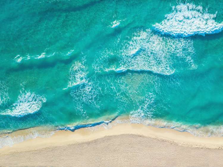 The sea laps the shore in the Caribbean