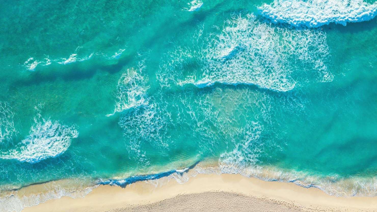 The sea laps the shore in the Caribbean