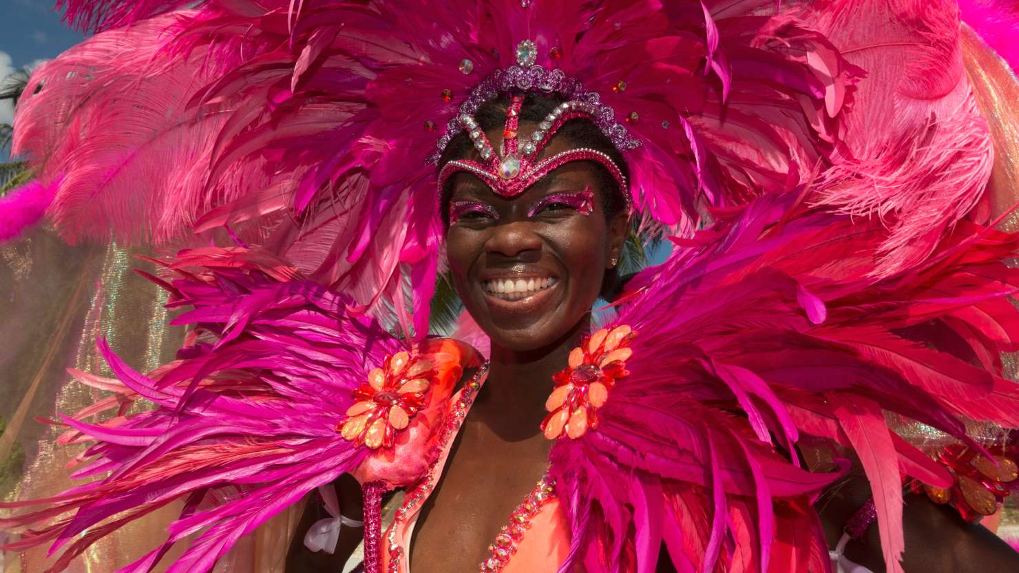 Local woman wearing a huge colourful headdress during the Barbados Crop Over festival.