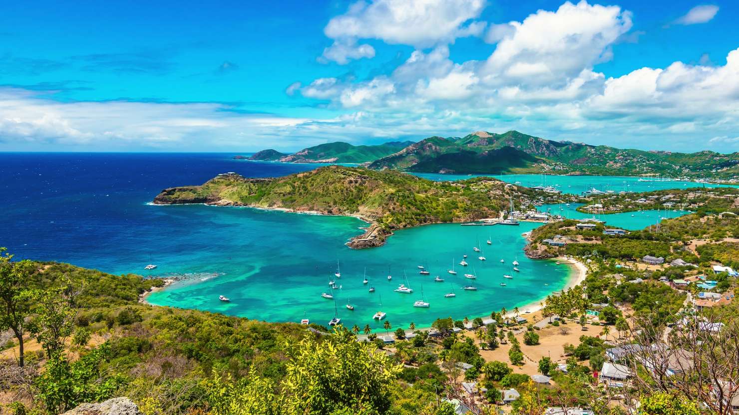 Beautiful bright and colorful aerial view of English harbor, Shirley Heights in Antigua, Caribbean. Landscape with blue sky and white clouds.