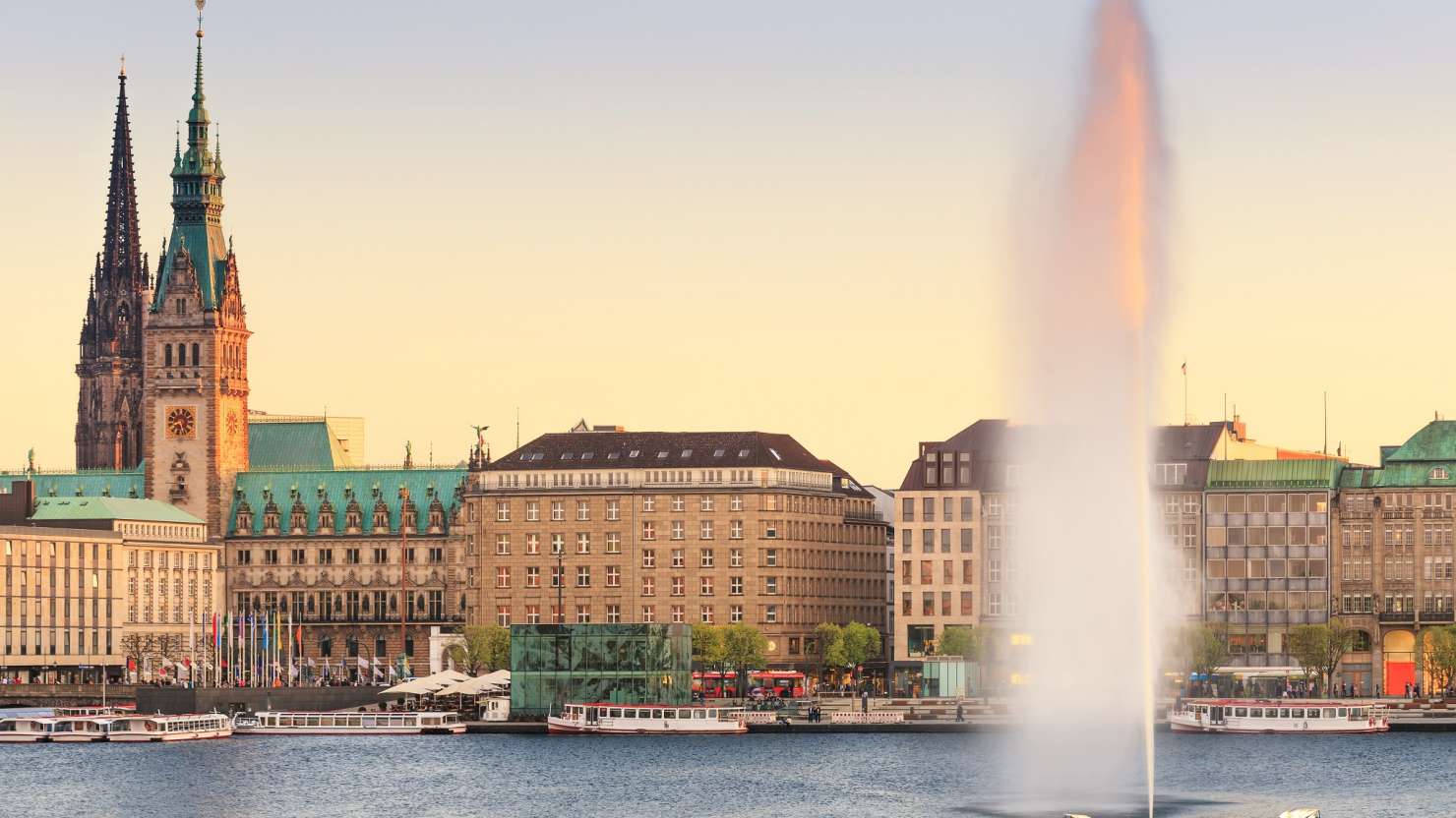 The Lake Binnenalster in Hamburg in Germany during spring time. In the foreground the famous Alster Lake fountain.