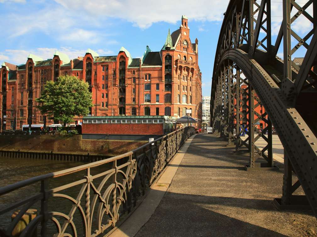 Germany. Hamburg. The Brooks-Brucke Bridge over the canal in Speicherstadt (City of Warehouses) with the historical red brick warehouses buildings in the background