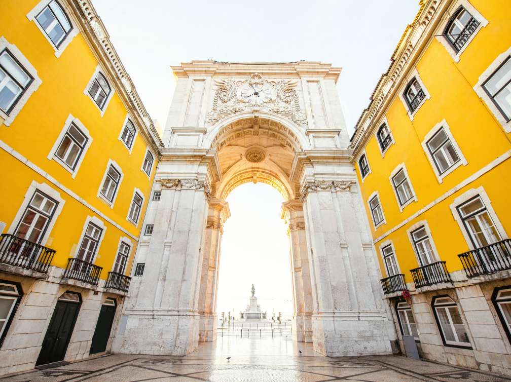 View on the Triumphal arch on the Commerce square during the sunrise in Lisbon city, Portugal