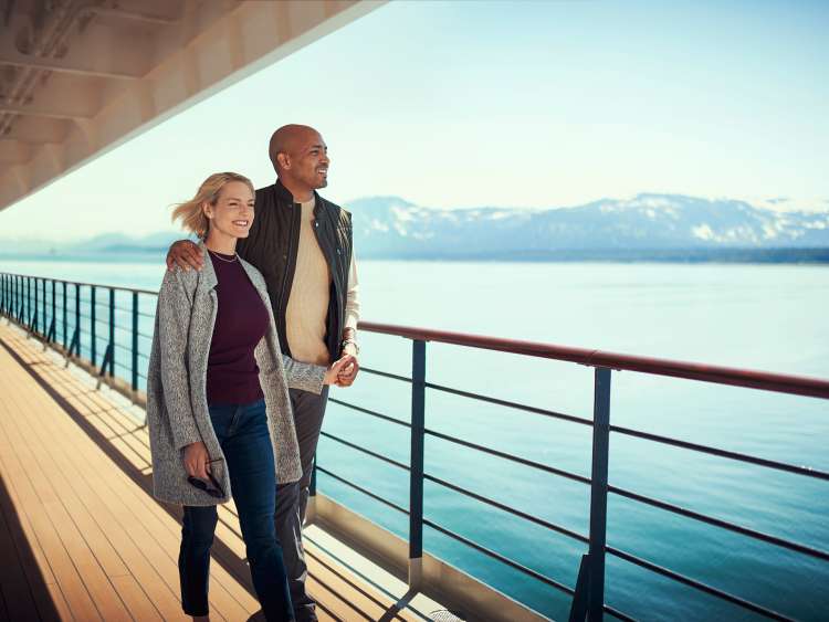 Guests on Queen Elizabeth's promenade deck in Alaska