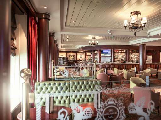Golden Lion pub on Queen Mary 2 , showing booth seating and bar with wine, beers and spirits