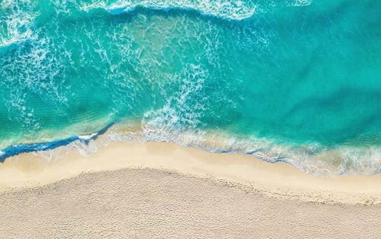 Caribbean seaside beach with turquoise water and big waves aerial view. Cancun beach aerial view.