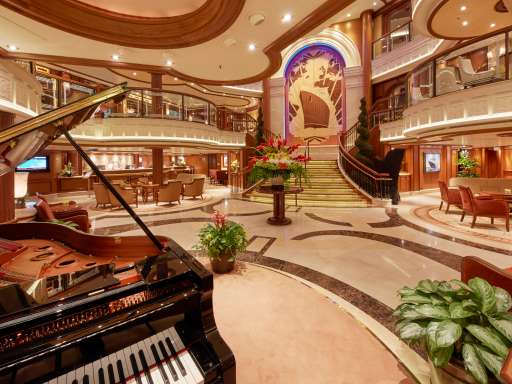 The Grand Lobby on board Cunard's Queen Elizabeth, with grand staircase, seating areas and grand piano