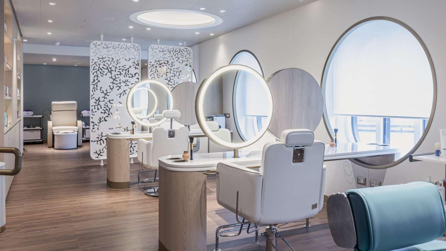 Salon on Queen Anne, showing treatment areas with sea views, circular lit mirrors, and pedicure area