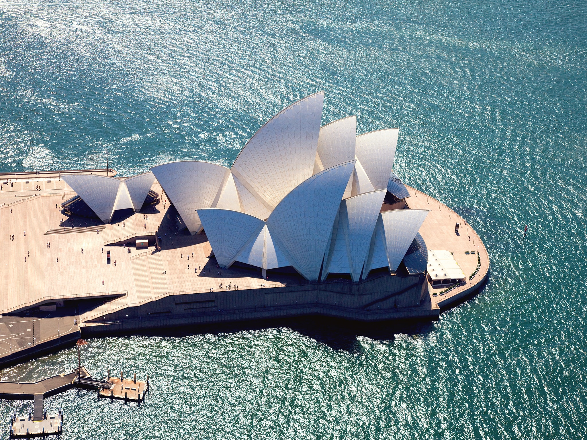 {"metadata_en_GB":{"alt-text":"An aerial view of the Sydney Opera House in Sydney, Australia, showcasing its iconic shell-like white sail structures situated on a point surrounded by sparkling blue water."},"metadata_de_DE":{"alt-text":"An aerial view of the Sydney Opera House in Sydney, Australia, showcasing its iconic shell-like white sail structures situated on a point surrounded by sparkling blue water."},"metadata_en_AU":{"alt-text":"An aerial view of the Sydney Opera House in Sydney, Australia, showcasing its iconic shell-like white sail structures situated on a point surrounded by sparkling blue water."},"metadata_en_US":{"alt-text":"An aerial view of the Sydney Opera House in Sydney, Australia, showcasing its iconic shell-like white sail structures situated on a point surrounded by sparkling blue water."}}