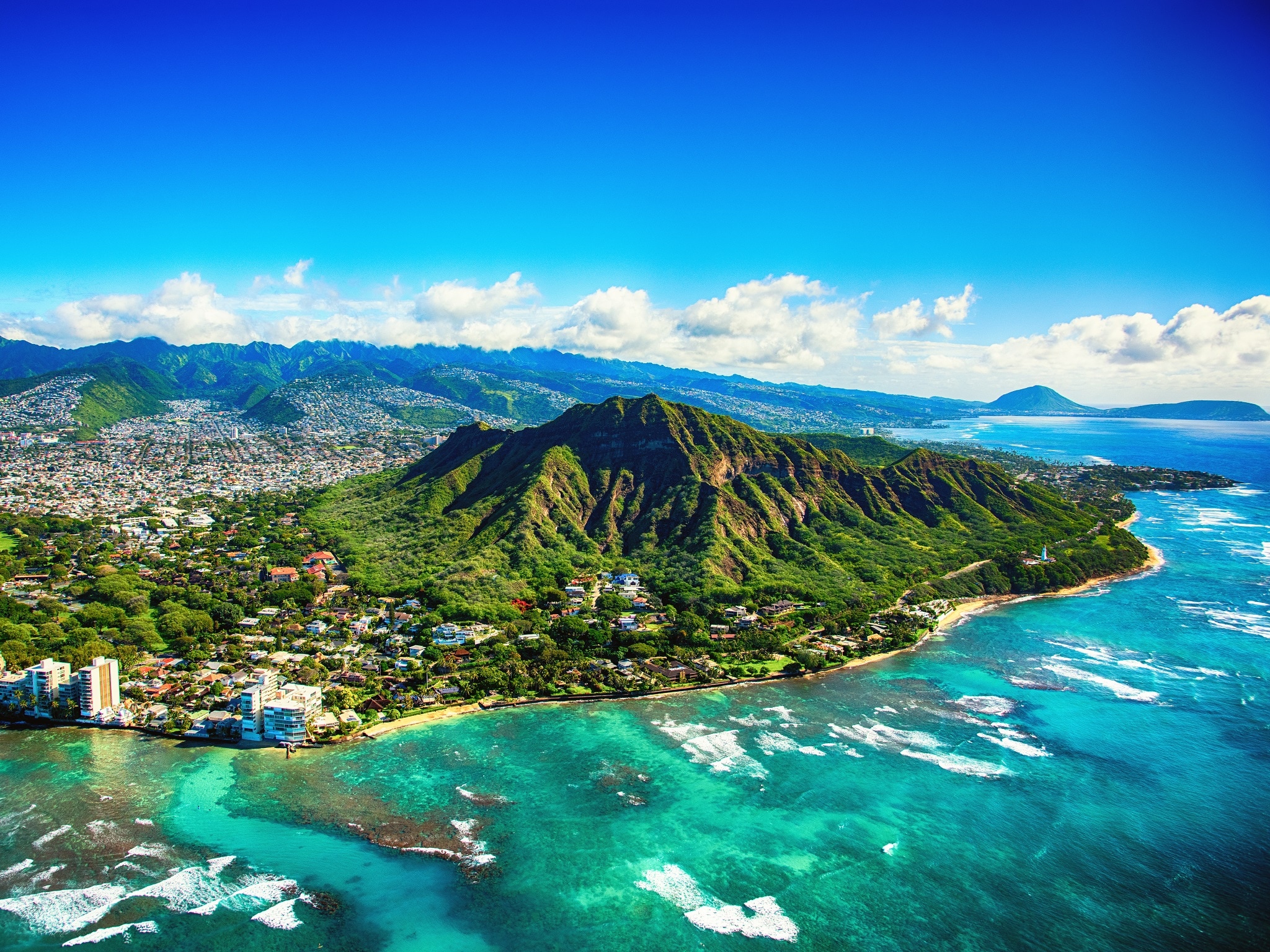 The dormant volcano known as Diamond Head located adjacent to downtown Honlulu, Hawaii, as shot from an altitude of about 1500 feet over the Pacific Ocean.