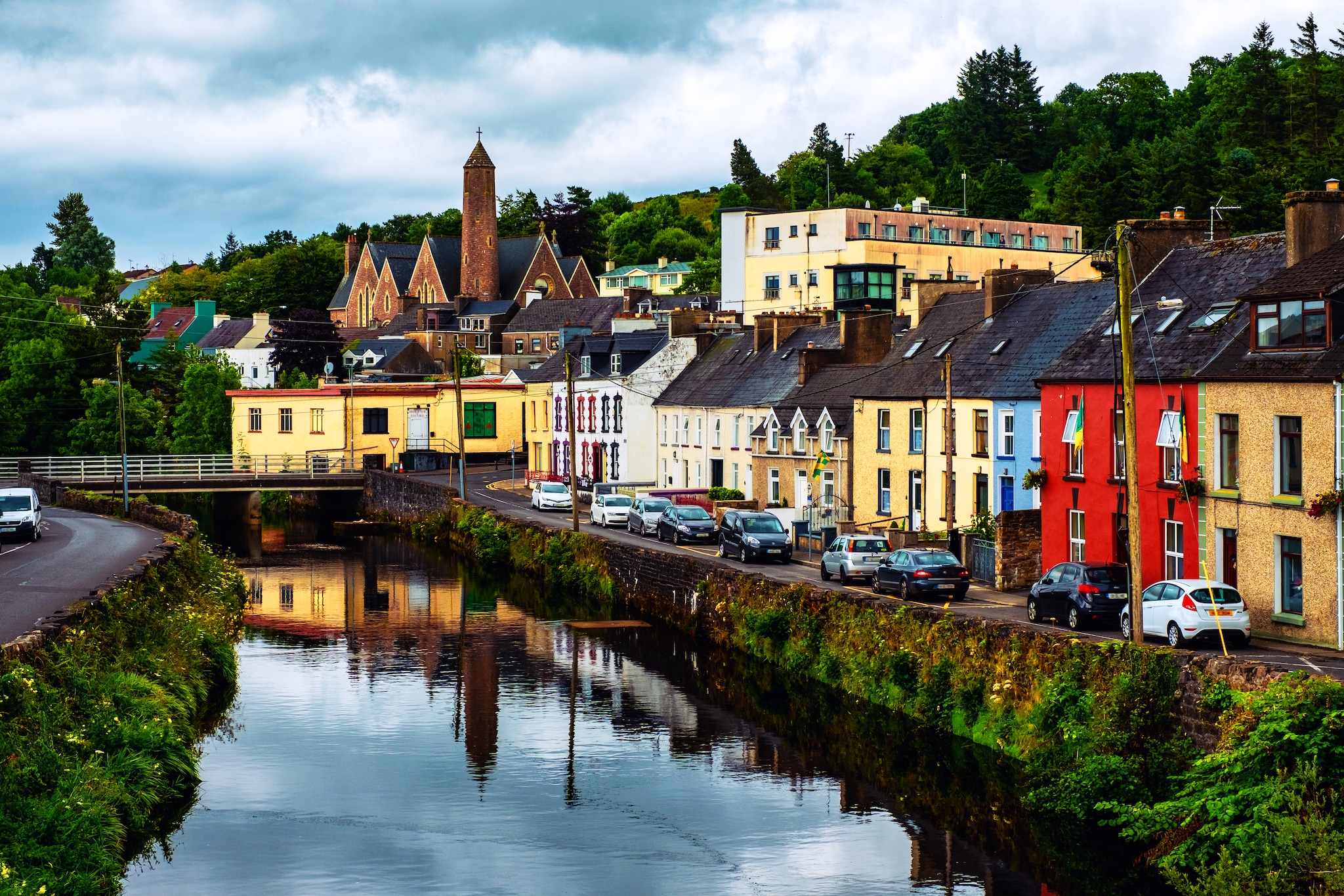 Donegal, Ireland. Beautiful landscape in Donegal, Ireland with river and colorful houses. Cloudy sky in summer, old bridge over the river; Shutterstock ID 1119048308; Invoice Number: -