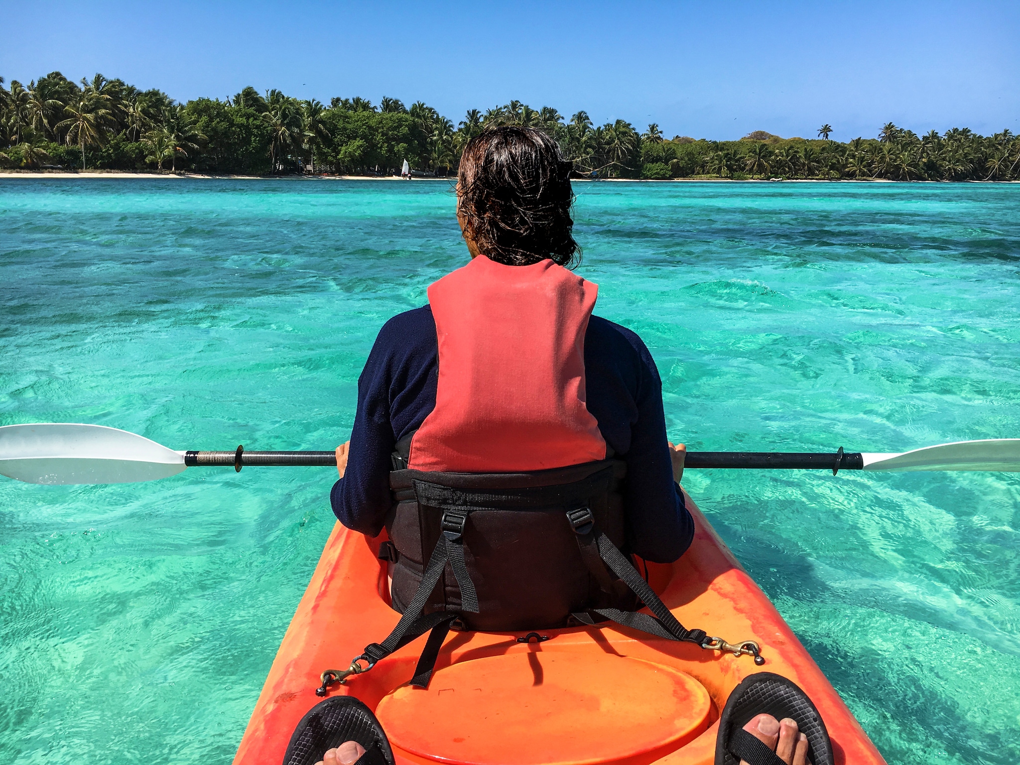 Enjoying a sit on top ocean kayak in Lighthouse Reef Atoll. Belize Caribbean.