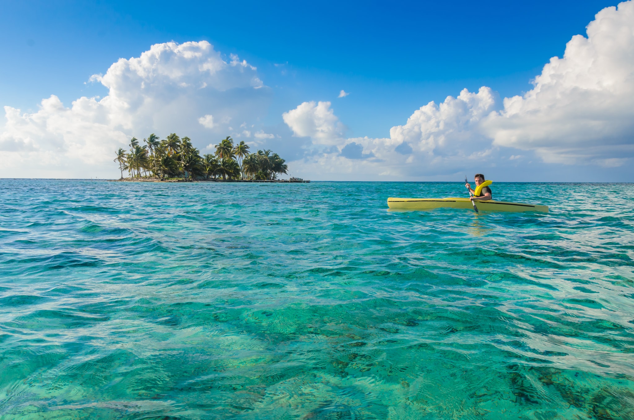 Kayaking in tropical paradise - Canoe floating on transparent turquoise water, Caribbean sea, Belize