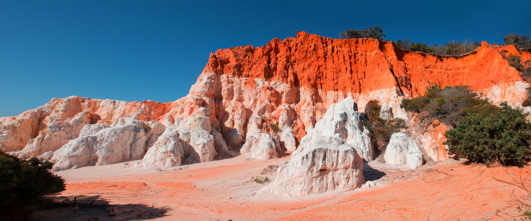 Pinnacles, to be found in Ben Boyd National Park near Merimbula, the beautiful reds and pure white colors of the formations can be seen from the lookout or from a long walk from the beach.; Shutterstock ID 1141120799; Invoice Number: -
