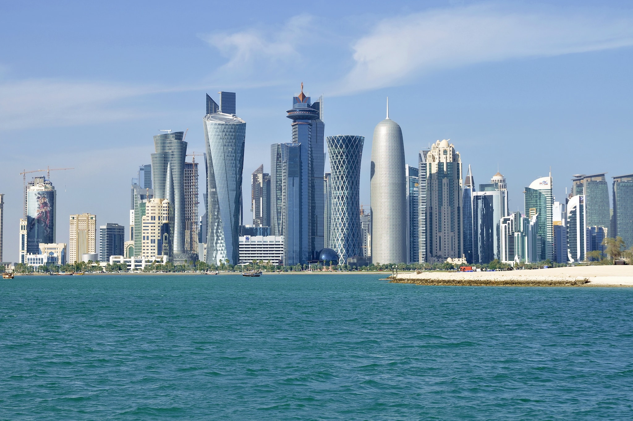 Modern skyscrapers line the waterfront in Doha, Qatar