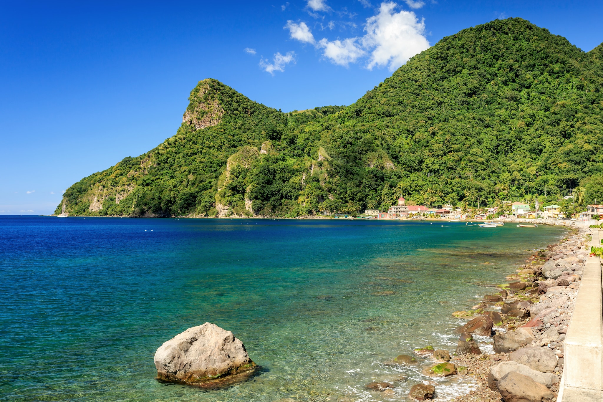 {"metadata_en_GB":{"alt-text":"View across a bay with rocky shoreline, green hills and a terracotta-roofed village in the distance in Dominica, Caribbean"},"metadata_en_AU":{"alt-text":"View across a bay with rocky shoreline, green hills and a terracotta-roofed village in the distance in Dominica, Caribbean"},"metadata_en_US":{"alt-text":"View across a bay with rocky shoreline, green hills and a terracotta-roofed village in the distance in Dominica, Caribbean"}}