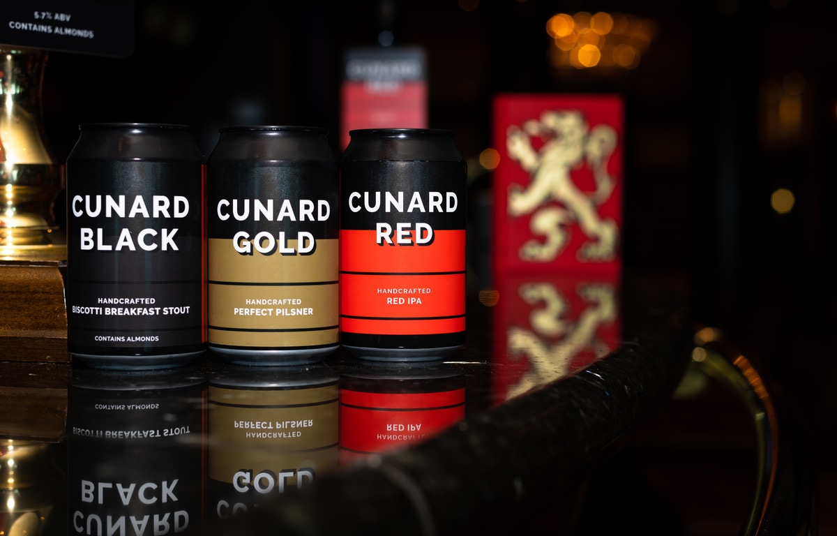 {"metadata_en_GB":{"alt-text":"Cans of Cunard Black, Cunard Gold and Cunard Red beers on the bar of the Golden Lion pub."},"metadata_en_AU":{"alt-text":"Cans of Cunard Black, Cunard Gold and Cunard Red beers on the bar of the Golden Lion pub."},"metadata_en_US":{"alt-text":"Cans of Cunard Black, Cunard Gold and Cunard Red beers on the bar of the Golden Lion pub."}}