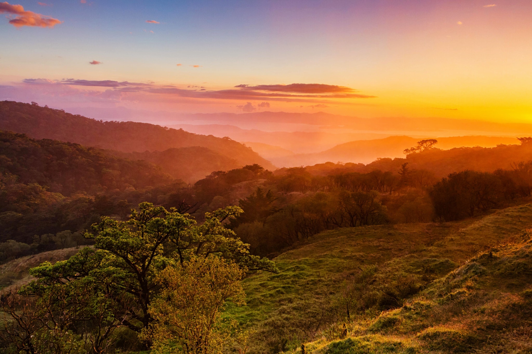 Foothills of Monteverde, Santa Elena in Costa Rica highlands. Panoramic view in beautiful orange sunset day of a vast hills and mountains in this pristine region of Central America
; Shutterstock ID 1162541485; purchase_order: -; job: -; client: -; other: -
