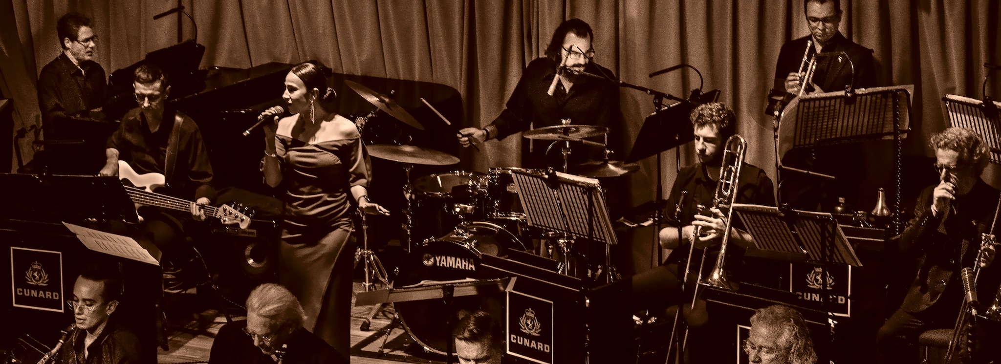 {"metadata_en_GB":{"alt-text":"The Queens Room Musicians with vocalist Rebecca Southard"},"metadata_en_AU":{"alt-text":"The Queens Room Musicians with vocalist Rebecca Southard"},"metadata_en_US":{"alt-text":"The Queens Room Musicians with vocalist Rebecca Southard"}}