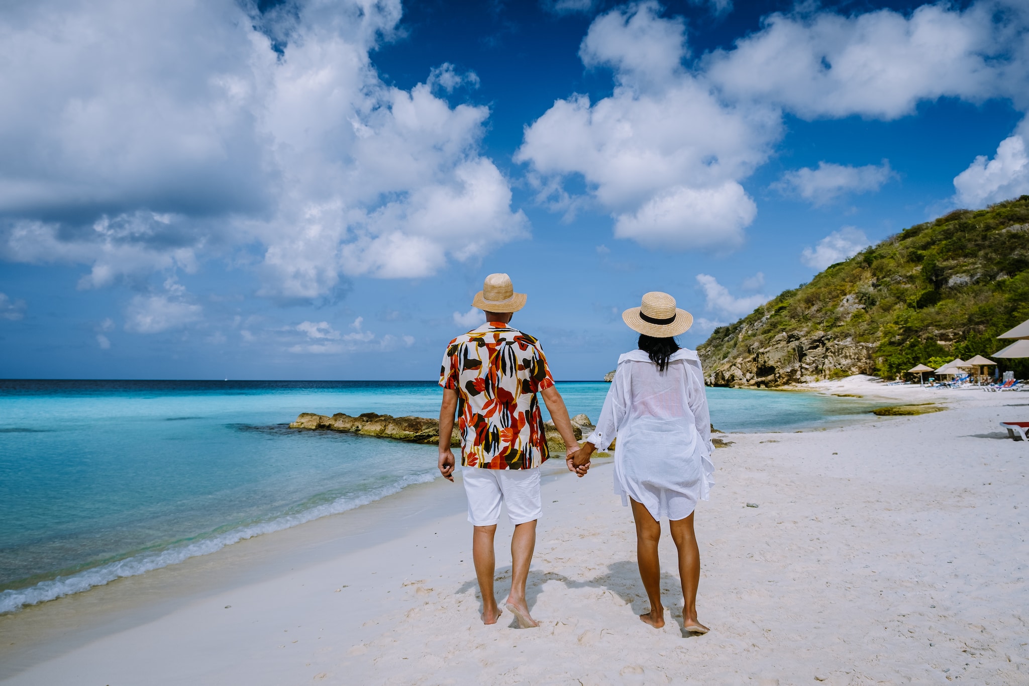 Cas Abou Beach Curacao on the caribbean island of Curacao, Playa Cas Abou in Curacao Caribbean tropical white beach with blue ocean men and woman on the beach, couple mid age on vacation; Shutterstock ID 1976178758; purchase_order: n/a; job: Caribbean Guide; client: cunard_digital; other: