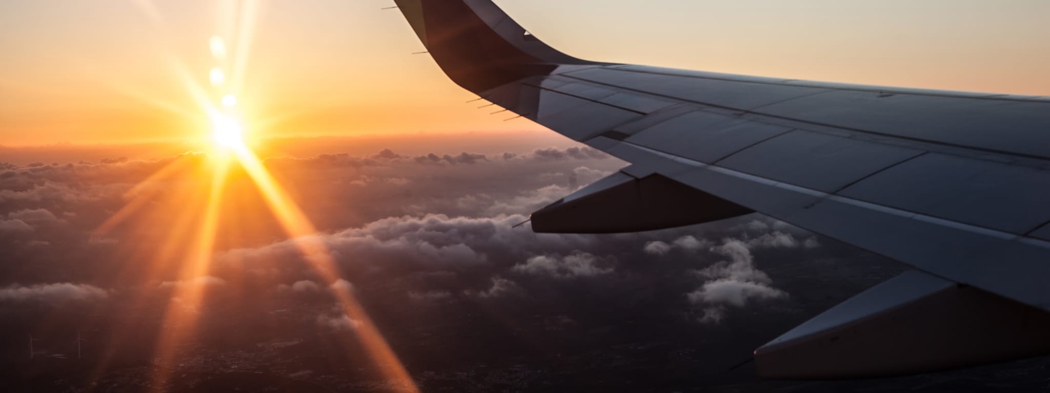 Sunset in airplane with wing - Shutterstock ID 680534296