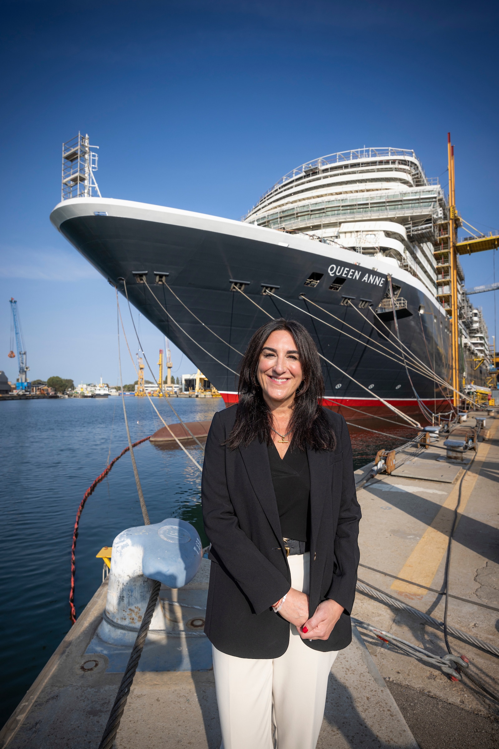 EDITORIAL FREE TO USE PHOTOGRAPH 
EMBARGOED UNTIL 1100GMT THURSDAY 5TH OCTOBER; 2023
Katie McAlister, Cunard President under the bow of Cunards newest ship, Queen Anne, during the final phase of her construction at the Fincantieri ship yard near Venice, Italy. 
The fourth ship in the fleet will enter service in six months time on May 3rd; 2024.
Client: Cunard. 
For further information, please contact Sam Cole, Global PR & Events Director on Sam.Cole@cunard.co.uk, also Hannah Reay on Hannah.Reay@cunard.co.uk and Sam Balls on sam.balls@cunard.co.uk

Picture date: Thursday October 5, 2023.
Photograph by Christopher Ison ©
07544044177
chris@christopherison.com
www.christopherison.com