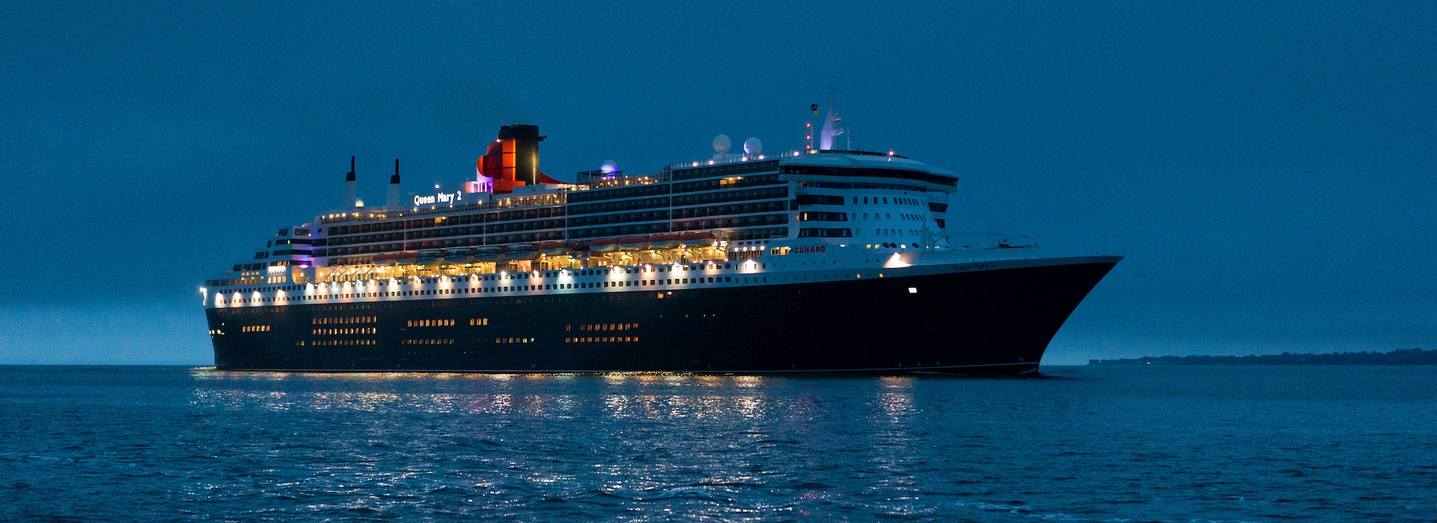 Brand shot of QM2 in Southampton Water
